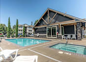Thumbnail 15 of 28 - A house with a pool in front of it at Silverplace Apartment Homes, Oregon