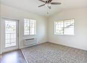 Thumbnail 6 of 28 - A room with a ceiling fan and two windows at Silverplace Apartment Homes, Silverton, OR