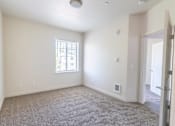 Thumbnail 9 of 28 - A room with a window and a door at Silverplace Apartment Homes, Silverton