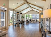 Thumbnail 13 of 22 - A spacious living room with a dining table and chairs. at St Helens Place Apartment Homes, St Helens, Oregon