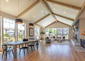 Thumbnail 14 of 22 - A spacious living room with a high ceiling and wooden floors at St Helens Place Apartment Homes, St Helens, OR