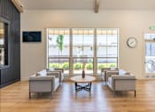 Thumbnail 19 of 22 - A living room with a large window and a flat screen TV mounted on the wall. at St Helens Place Apartment Homes, St Helens, OR, 97051