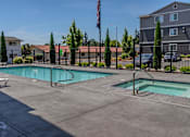 Thumbnail 2 of 22 - A swimming pool surrounded by a fence and trees at St Helens Place Apartment Homes, Oregon, 97051