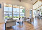Thumbnail 20 of 22 - A living room with a grey sofa and a wooden floor at St Helens Place Apartment Homes, St Helens, Oregon