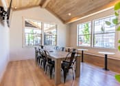 Thumbnail 22 of 22 - A room with a long table and chairs with a window in the background at St Helens Place Apartment Homes, St Helens, OR, 97051