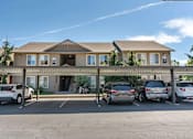 Thumbnail 15 of 46 - A building with a parking lot in front of it at Stoneplace Apartment Homes, Molalla, Oregon