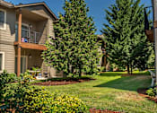 Thumbnail 17 of 46 - A residential area with a house, trees, and a lawn at Stoneplace Apartment Homes, Molalla, Oregon