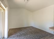 Thumbnail 18 of 46 - A room with a carpeted floor and a table at Stoneplace Apartment Homes, Molalla, 97038