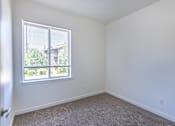 Thumbnail 24 of 46 - A room with a window and a carpeted floor at Stoneplace Apartment Homes, Oregon, 97038