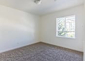 Thumbnail 25 of 46 - A room with a carpeted floor and a window at Stoneplace Apartment Homes, Oregon