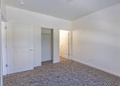 Thumbnail 26 of 46 - A room with white walls and carpeted floor with two doors at Stoneplace Apartment Homes, Molalla, OR
