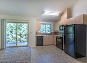 Thumbnail 30 of 46 - A kitchen with black appliances and a black refrigerator at Stoneplace Apartment Homes, Molalla, Oregon