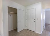 Thumbnail 31 of 46 - A white door is open to a hallway at Stoneplace Apartment Homes, Molalla