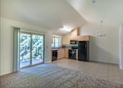 Thumbnail 32 of 46 - A spacious living room with a kitchen area in the background at Stoneplace Apartment Homes, Molalla