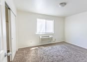 Thumbnail 33 of 46 - A room with a window and a carpeted floor at Stoneplace Apartment Homes, Molalla, Oregon