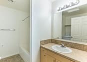 Thumbnail 35 of 46 - A bathroom with a sink, mirror, and towel rack at Stoneplace Apartment Homes, Molalla, 97038