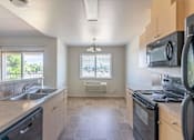 Thumbnail 39 of 46 - A kitchen with a stove, microwave, and oven at Stoneplace Apartment Homes, Molalla, OR, 97038