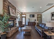 Thumbnail 4 of 46 - A living room with a fireplace and a couch at Stoneplace Apartment Homes, Oregon, 97038