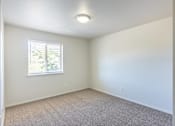Thumbnail 43 of 46 - A room with a window and carpeted floor at Stoneplace Apartment Homes, Molalla, OR