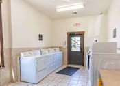 Thumbnail 8 of 46 - A bathroom with a row of sinks and a door at Stoneplace Apartment Homes, Oregon, 97038