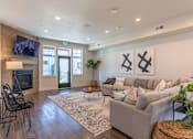 Thumbnail 12 of 12 - A living room with a grey couch, a television, and a rug at Timberridge Place Apartment Homes, Albany