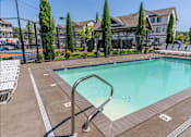 Thumbnail 6 of 12 - A pool surrounded by a fence and trees at Timberridge Place Apartment Homes, Albany, 97322