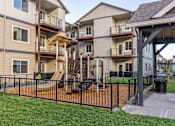 Thumbnail 8 of 49 - Apartment complex with a playground in the front at Woodburn Place Apartment Homes, Woodburn, 97071