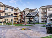 Thumbnail 13 of 49 - A courtyard with a tree in the middle of it at Woodburn Place Apartment Homes, Oregon, 97071