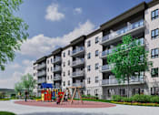 Thumbnail 3 of 24 - A large apartment building with a playground in front.