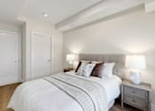 Thumbnail 21 of 24 - A bedroom with a large bed and two lamps.