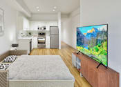 Thumbnail 7 of 24 - A modern living room with a television on a wooden stand.