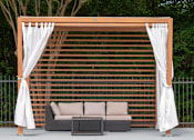 Thumbnail 9 of 16 - A poolside lounge area with a white canopy and a brown lattice backdrop.