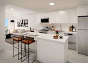 Thumbnail 8 of 8 - A modern kitchen with white cabinets and a large island.