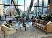 Thumbnail 5 of 16 - A living room with a large window and a view of the city.