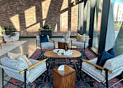 Thumbnail 6 of 16 - A cozy seating area with a wooden table and chairs.