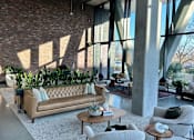 Thumbnail 7 of 16 - A living room with a couch, chairs, and a coffee table.