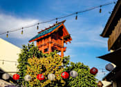 Thumbnail 14 of 18 - A traditional Japanese building with a red lantern hanging in front of it.