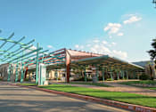 Thumbnail 18 of 19 - A large green structure is in front of a building.