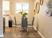 Thumbnail 5 of 34 - A dining room with a table and chairs.