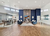 Thumbnail 1 of 23 - A modern living room with a fireplace and a dining area.