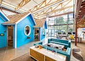 Thumbnail 3 of 19 - A blue house with a brown roof and a white counter.