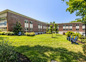 Thumbnail 2 of 33 - Lush, Green Outdoor Space with Chairs at 735 Truman, Hyde Park, Massachusetts