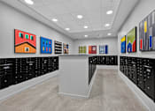 Thumbnail 15 of 38 - A hallway with a white wall and a row of black lockers on the right.