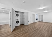 Thumbnail 27 of 38 - A room with a washing machine in the doorway.