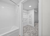Thumbnail 14 of 38 - A white bathroom with a walk-in closet.