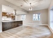 Thumbnail 39 of 51 - A spacious kitchen with wooden floors and a large island.