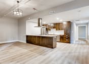 Thumbnail 40 of 51 - A kitchen with wooden floors and a large island.