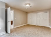 Thumbnail 29 of 51 - A room with a carpeted floor and a ceiling light.