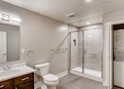 Thumbnail 26 of 51 - A bathroom with a toilet, sink, and shower.