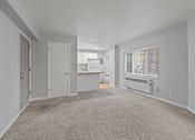 Thumbnail 45 of 51 - A spacious room with a carpeted floor and a window with blinds.